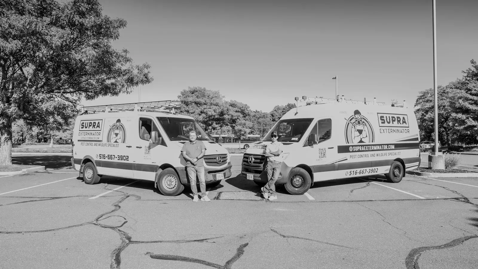 The Supra Exterminator owners in front of their service vans
